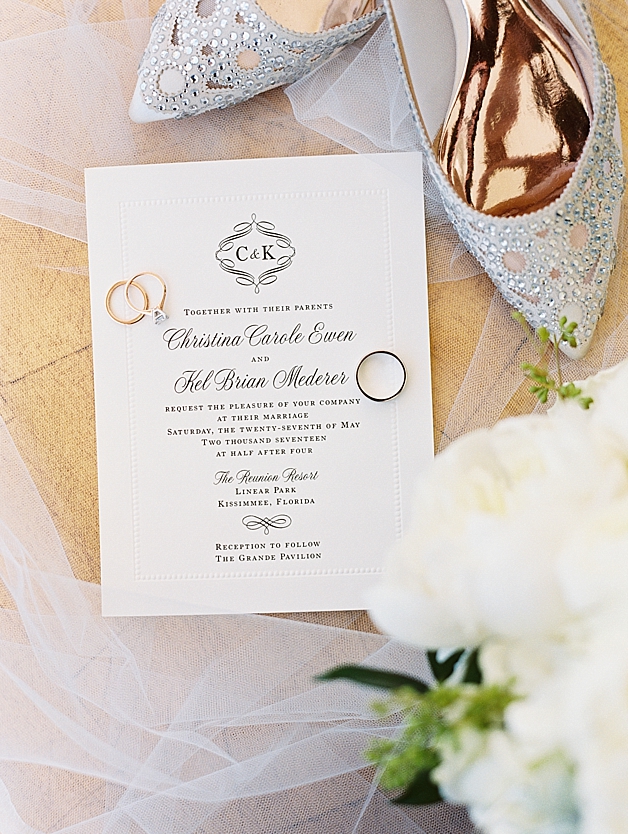Gold Wedding rings with Badgley Mischka heels and wedding day invitation suite