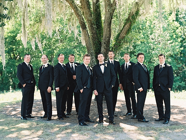 Groomsmen in black tuxes and bowties