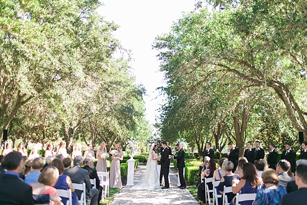Couple saying I do under a canopy of trees