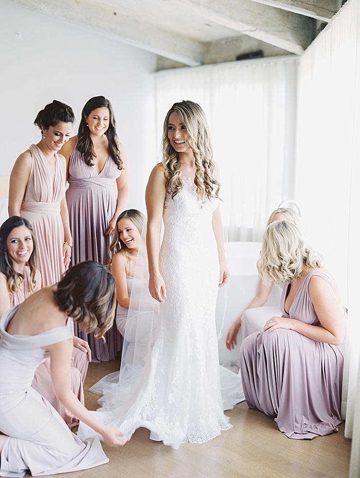 bridesmaids helping bride getting dressed | NYC Wedding Photographer | Beacon Roundhouse New York Wedding | photographed by Kt Crabb Photography