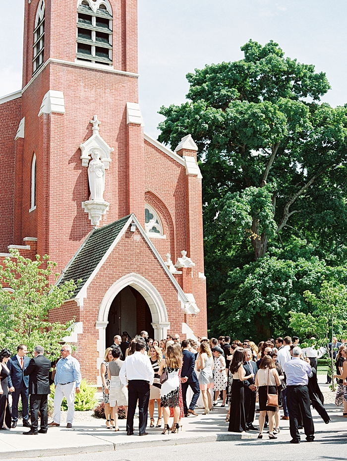 wide view of the outside of the cathedral with wedding guests leaving and congratulating the newly weds | NYC Wedding Photographer | Beacon Roundhouse New York Wedding | photographed by Kt Crabb Photography