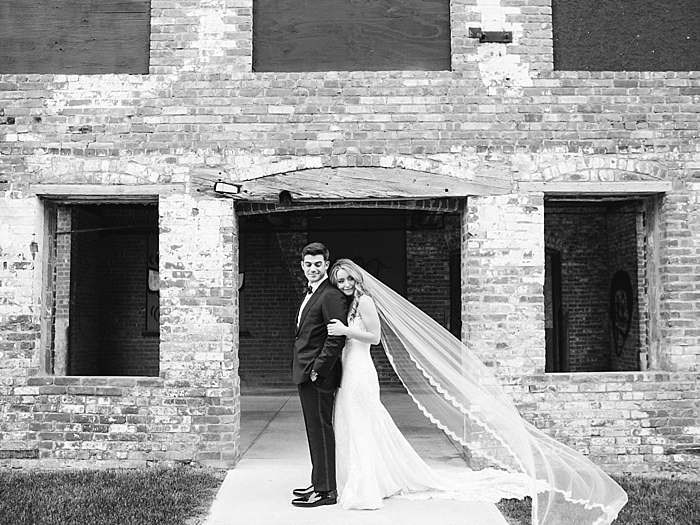 bride and groom standing in front of brick building in black and white | NYC Wedding Photographer | Beacon Roundhouse New York Wedding | photographed by Kt Crabb Photography