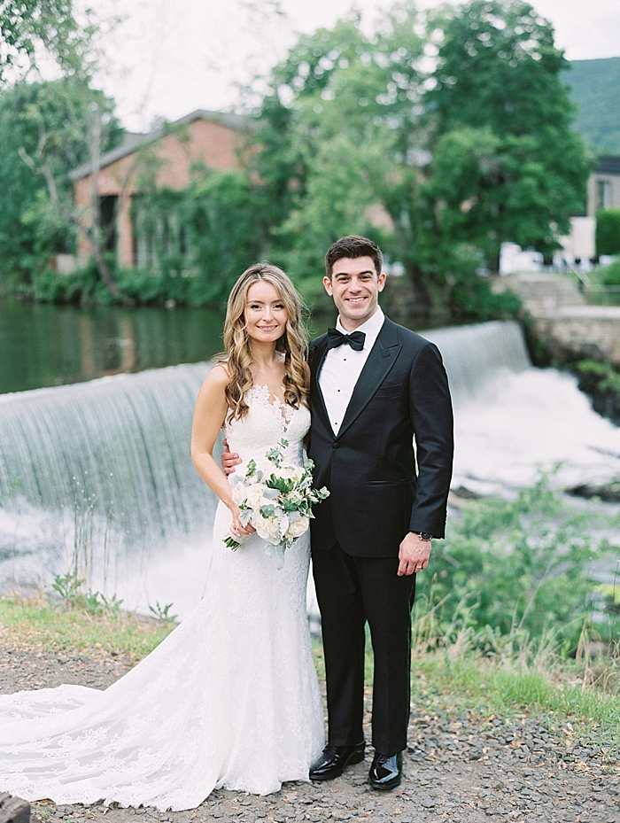 couple posed in front of waterfall during wedding day portraits | NYC Wedding Photographer | Beacon Roundhouse New York Wedding | photographed by Kt Crabb Photography