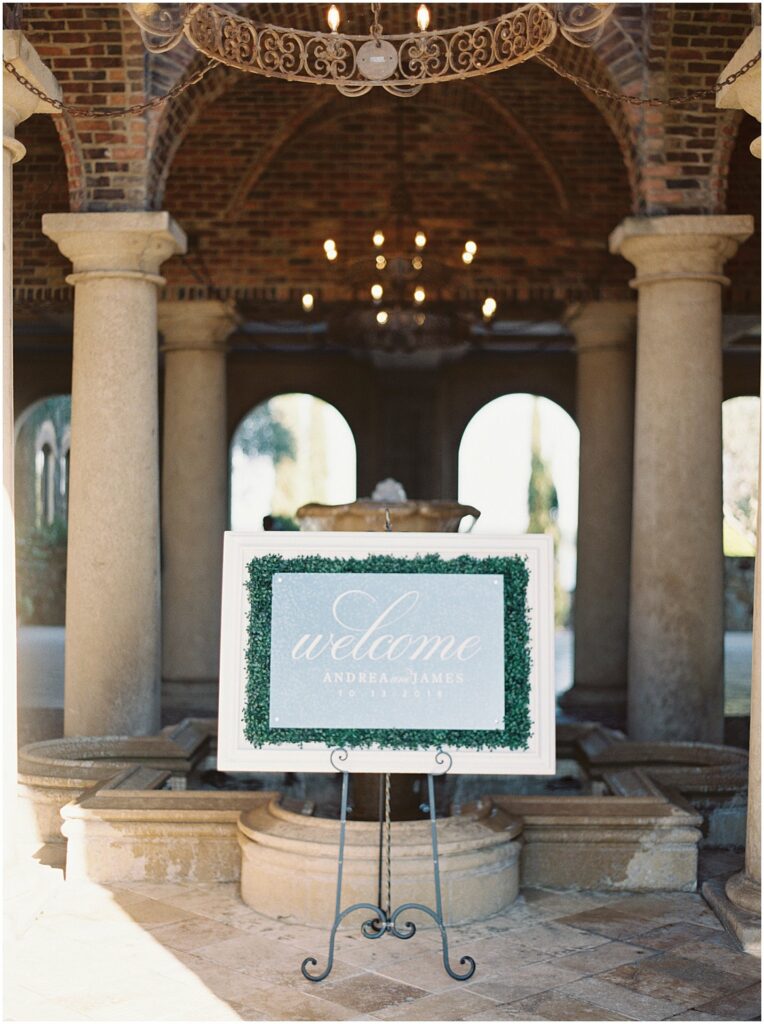 calligraphy on glass with foliage welcome sign at Bella Collina Orlando Wedding