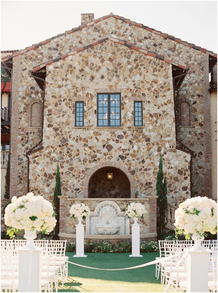 outdoor garden wedding with white flowers on columns at Bella Collina Orlando Wedding