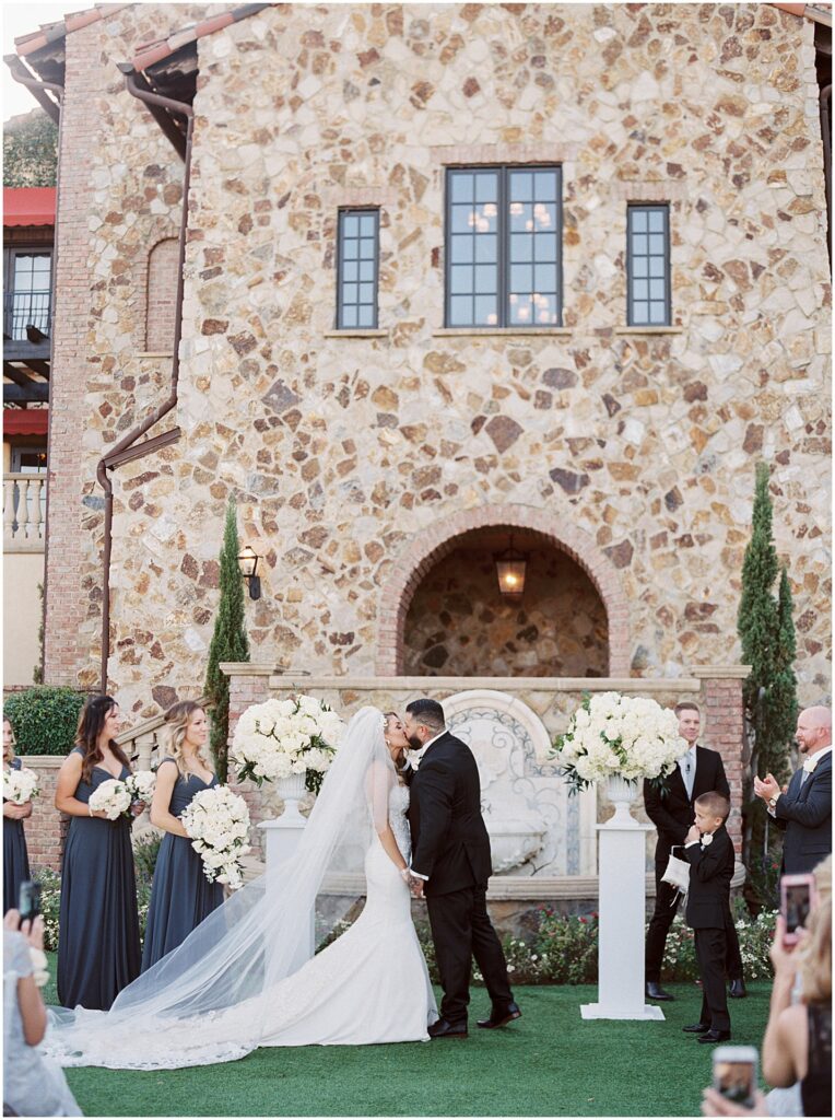 bride and groom's first kiss at ceremony at Bella Collina Orlando Wedding