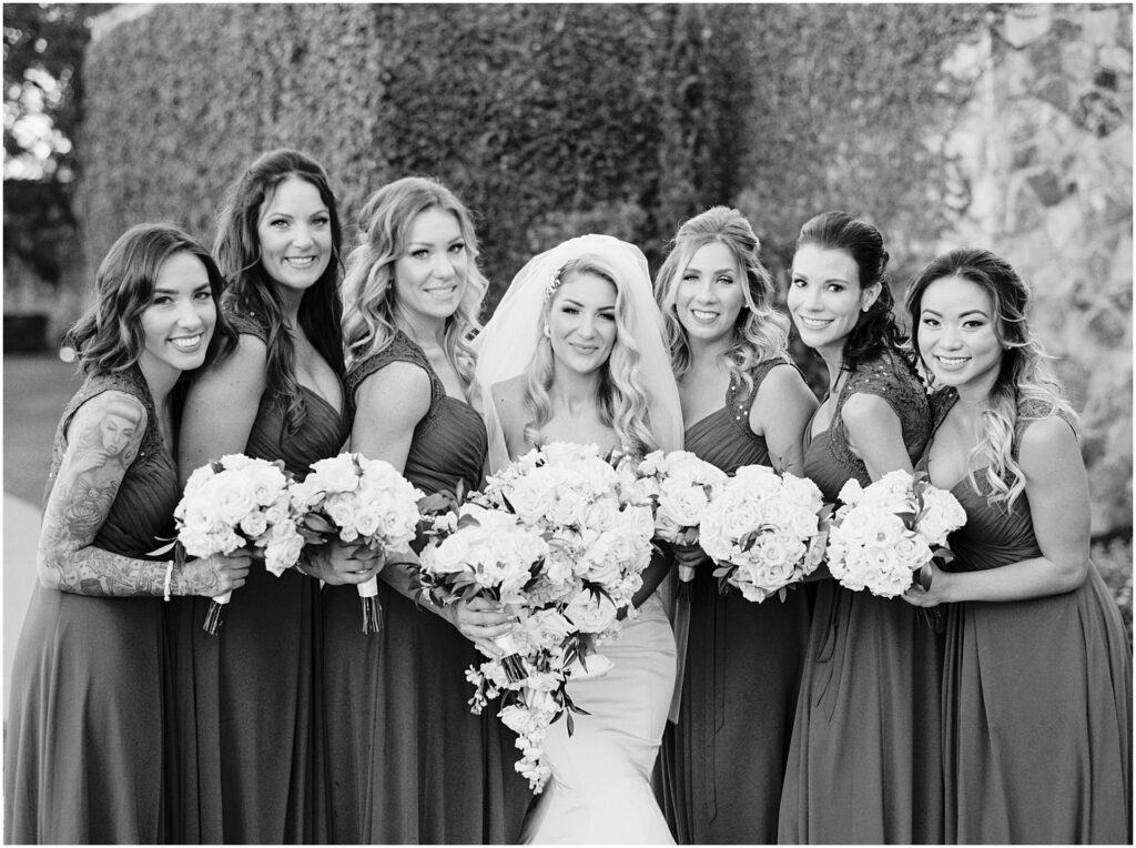bride and bridesmaids smiling for black and white photo at Bella Collina Orlando Wedding