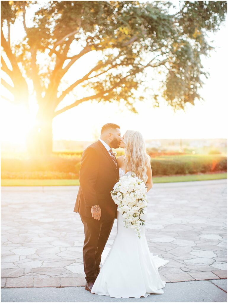 Golden hour sunset of bride and groom kissing at a wedding at Bella Collina