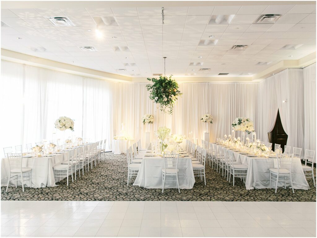 reception hall draped in white pipe and drape and white flowers at Bella Collina Orlando Wedding
