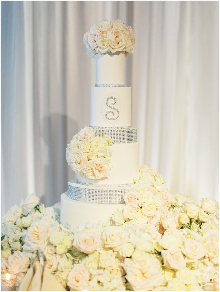 white cake covered in roses at Bella Collina Orlando Wedding