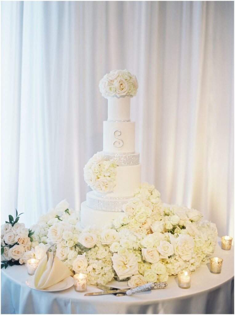 white four teared cake with large s monogram at Bella Collina Orlando Wedding