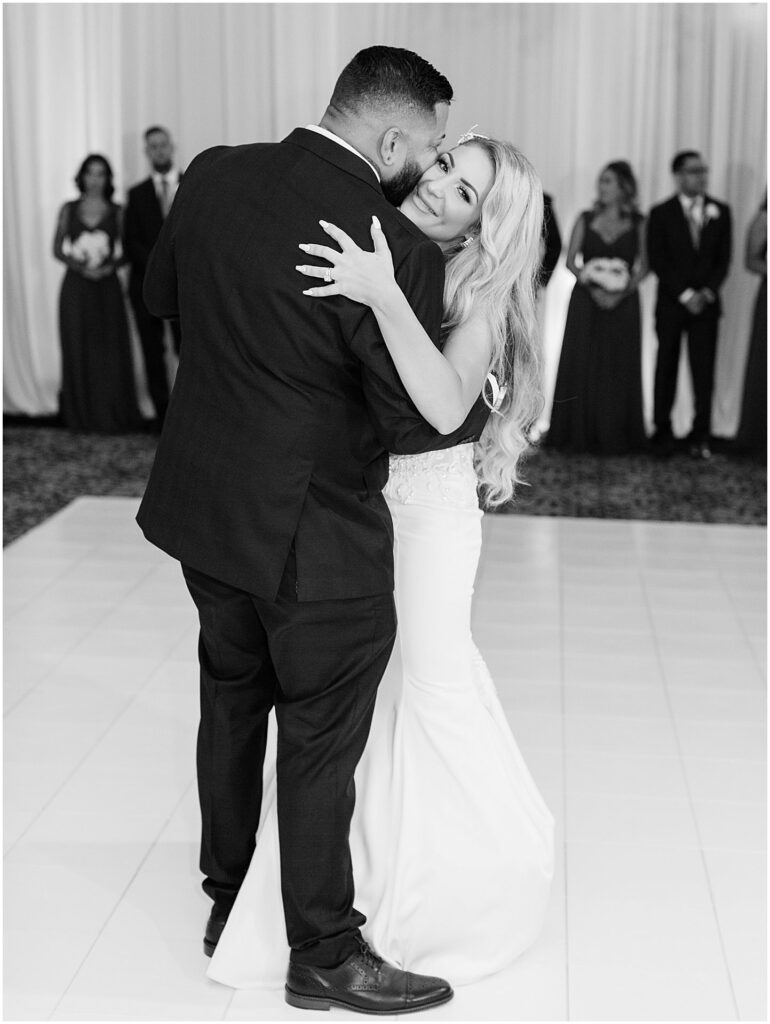 bride smiles at camera during first dance with groom at Bella Collina Orlando Wedding