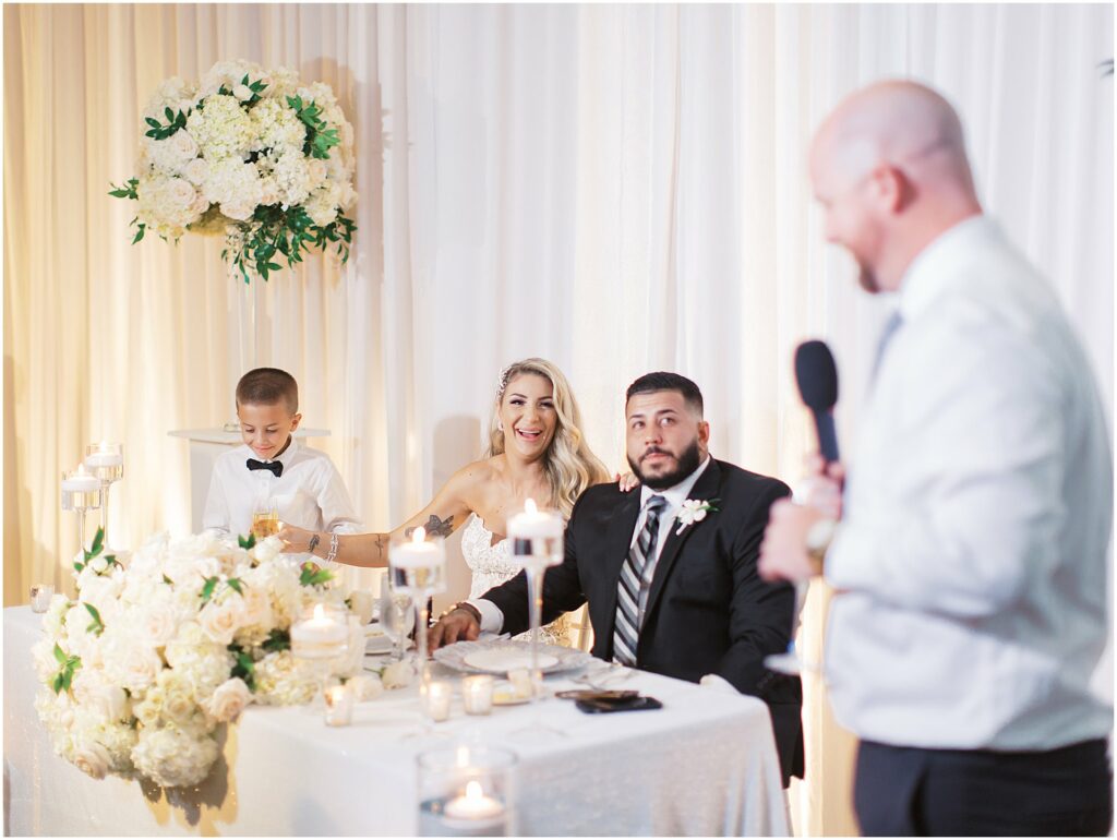 bride and groom laugh during toasts at Bella Collina Orlando Wedding
