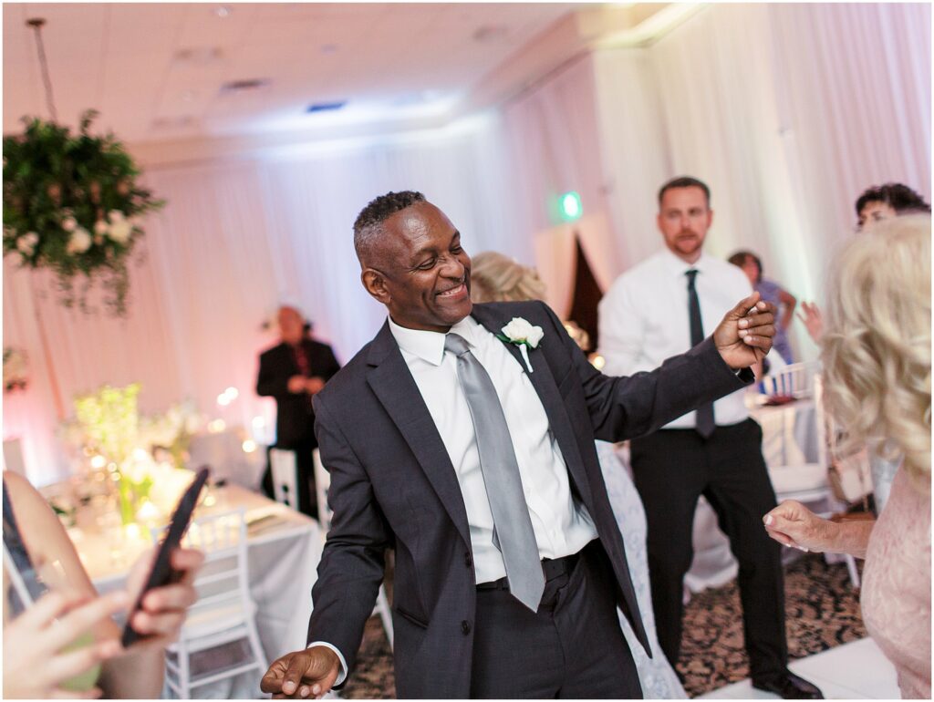 father of the groom dancing on dance floor at reception at Bella Collina Orlando Wedding