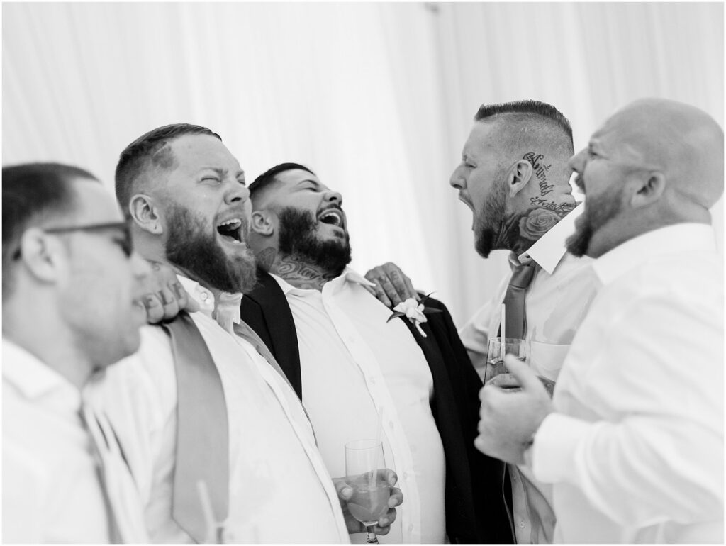 groom and groomsmen sing during reception at Bella Collina Orlando Wedding