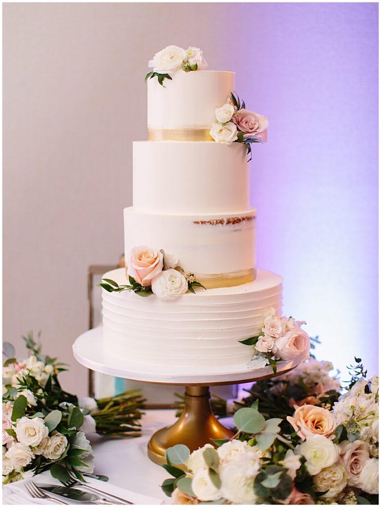 elegant white and gold cake with pink roses at the Addison in boca grande Miami wedding